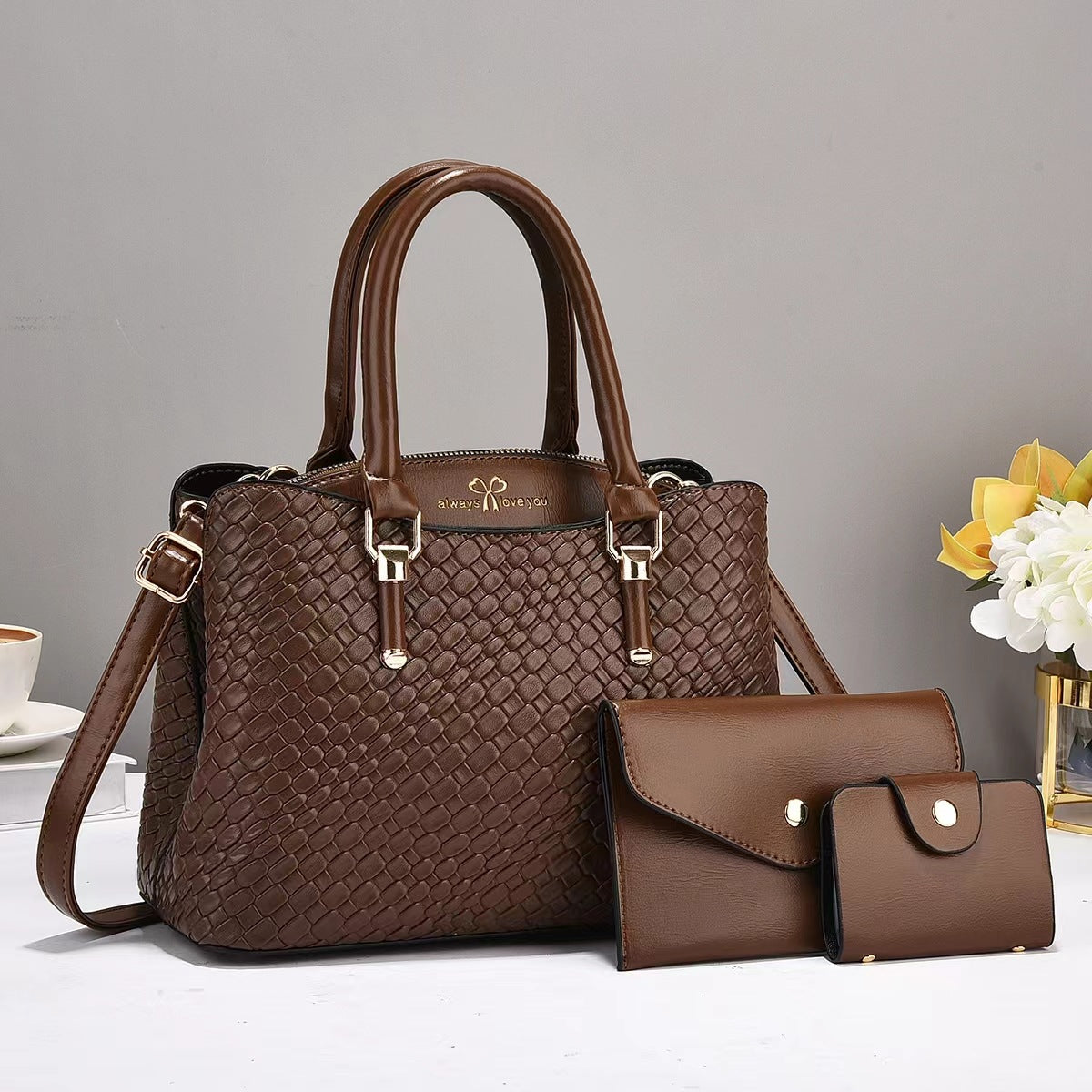 R&G Boutique woven texture three-piece set of large capacity one-shoulder combination bags on a plain background