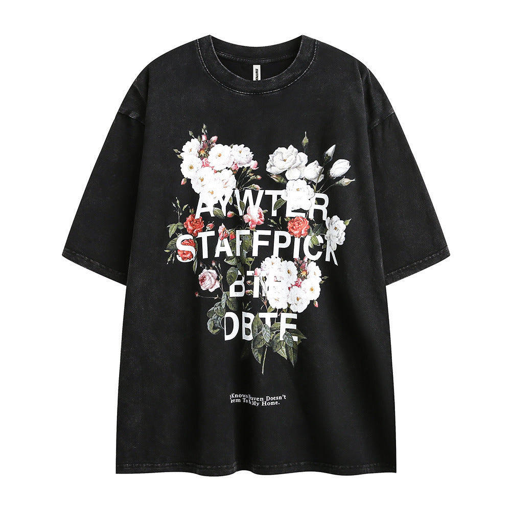 Men's short-sleeve t-shirt with floral letter print from R&G Boutique, showcasing a casual fashion design with colorful flower accents.
